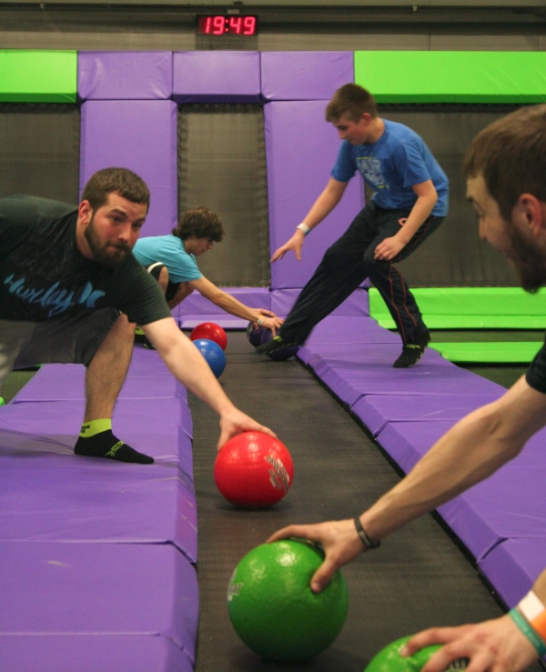 Men Grabbing Dodgeballs